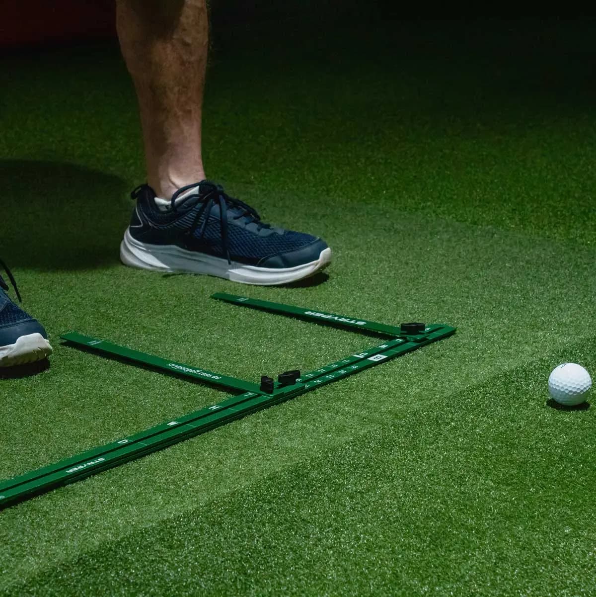 StanceMate viewed from above beside a golf ball